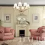 Classic-boiserie-fireplace-and-soft-armchairs-Bella-Vita-collection-Modenese-Gastone